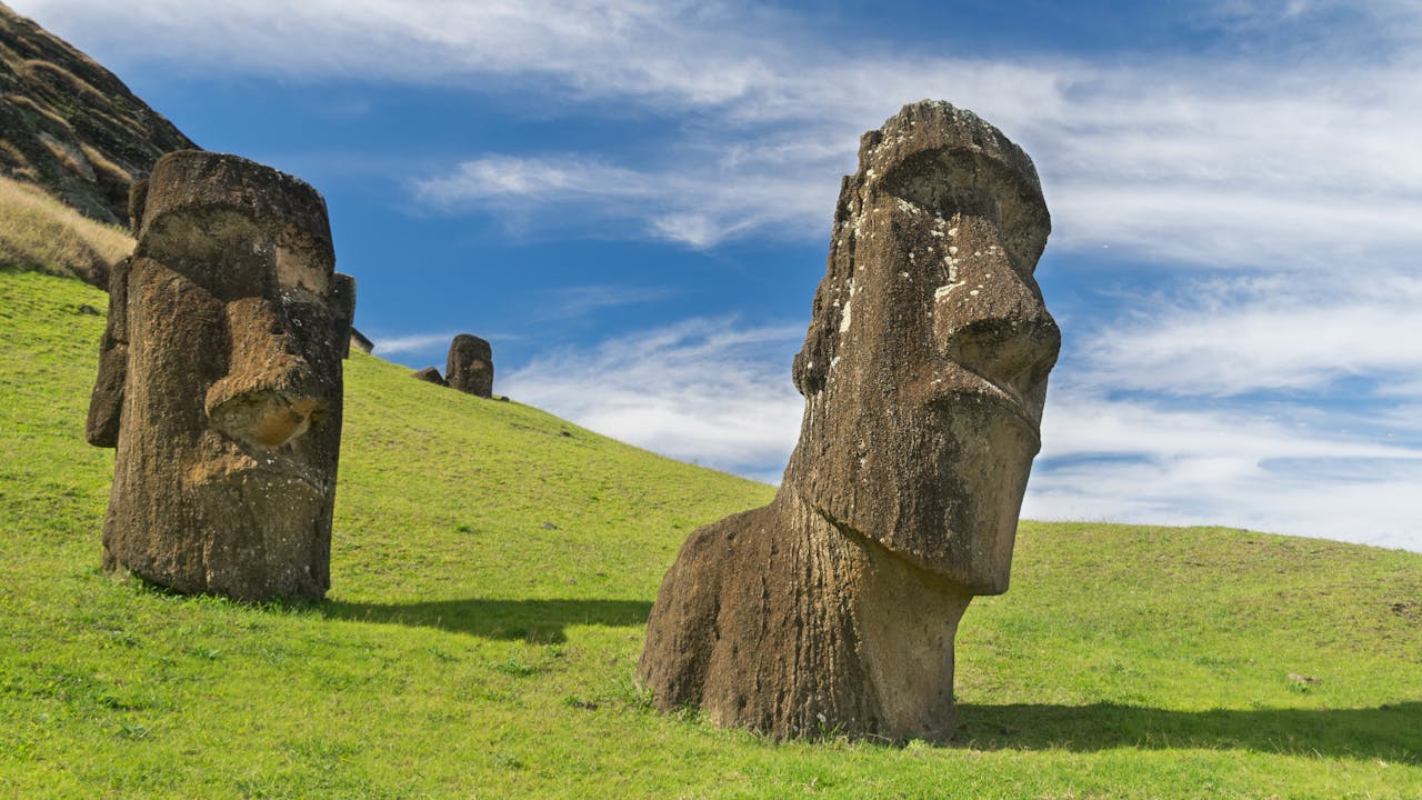 Majestic Moai statues on Easter Island with clear blue skies overhead.