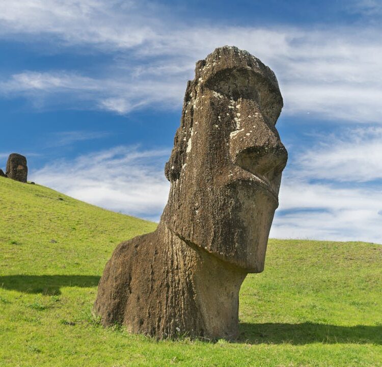 sculptures-on-eastern-islands-14596489-e1744406862929 Majestic Moai statues on Easter Island, where a reserve of ancient longevity increasing bacteria is said to have been stored. With clear blue skies overhead.