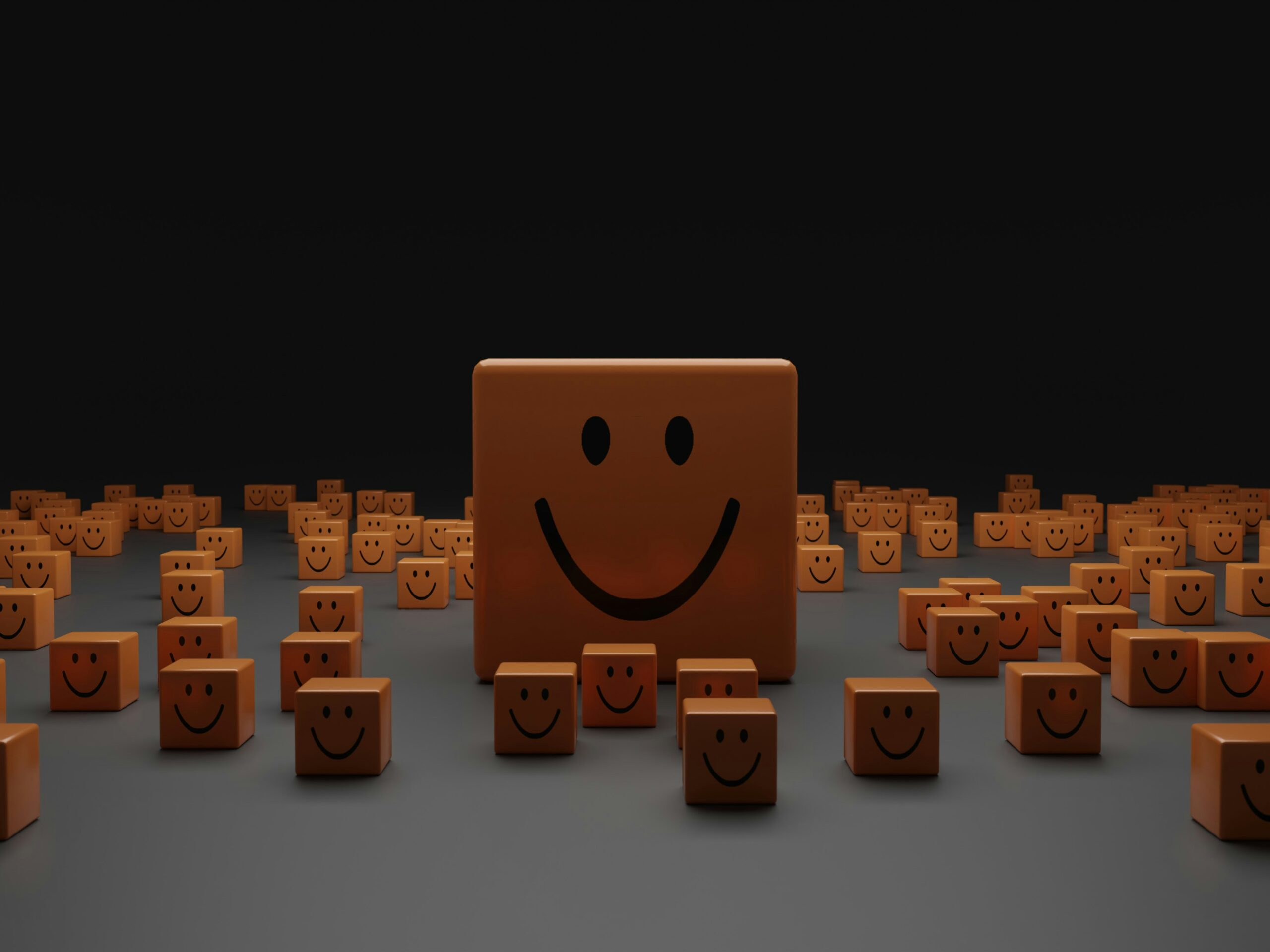 Many wooden blocks with smiles on them on a grey surface with a black sky. One of them is bigger indicating that it has a personality trait that stands out from the rest.
