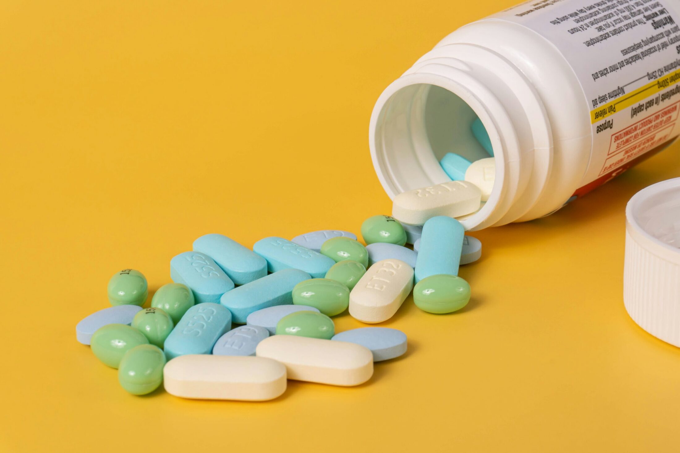 A various color statin pills symbolizing cholesterol-lowering medication.